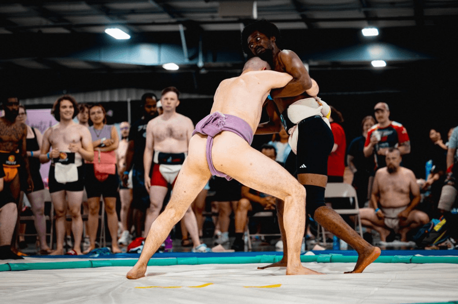 Two sumo wrestlers competing in a tournament